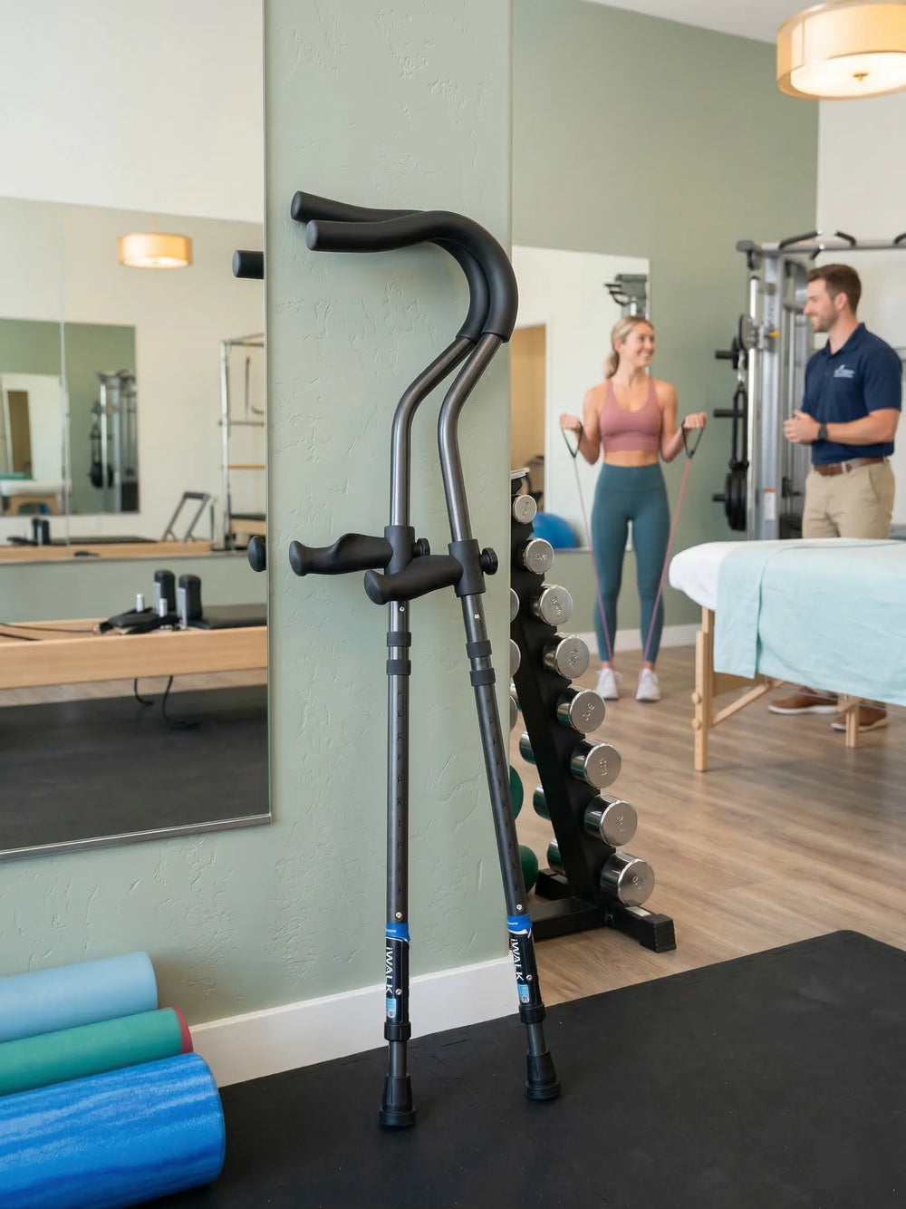 Gym equipment and two people exercising