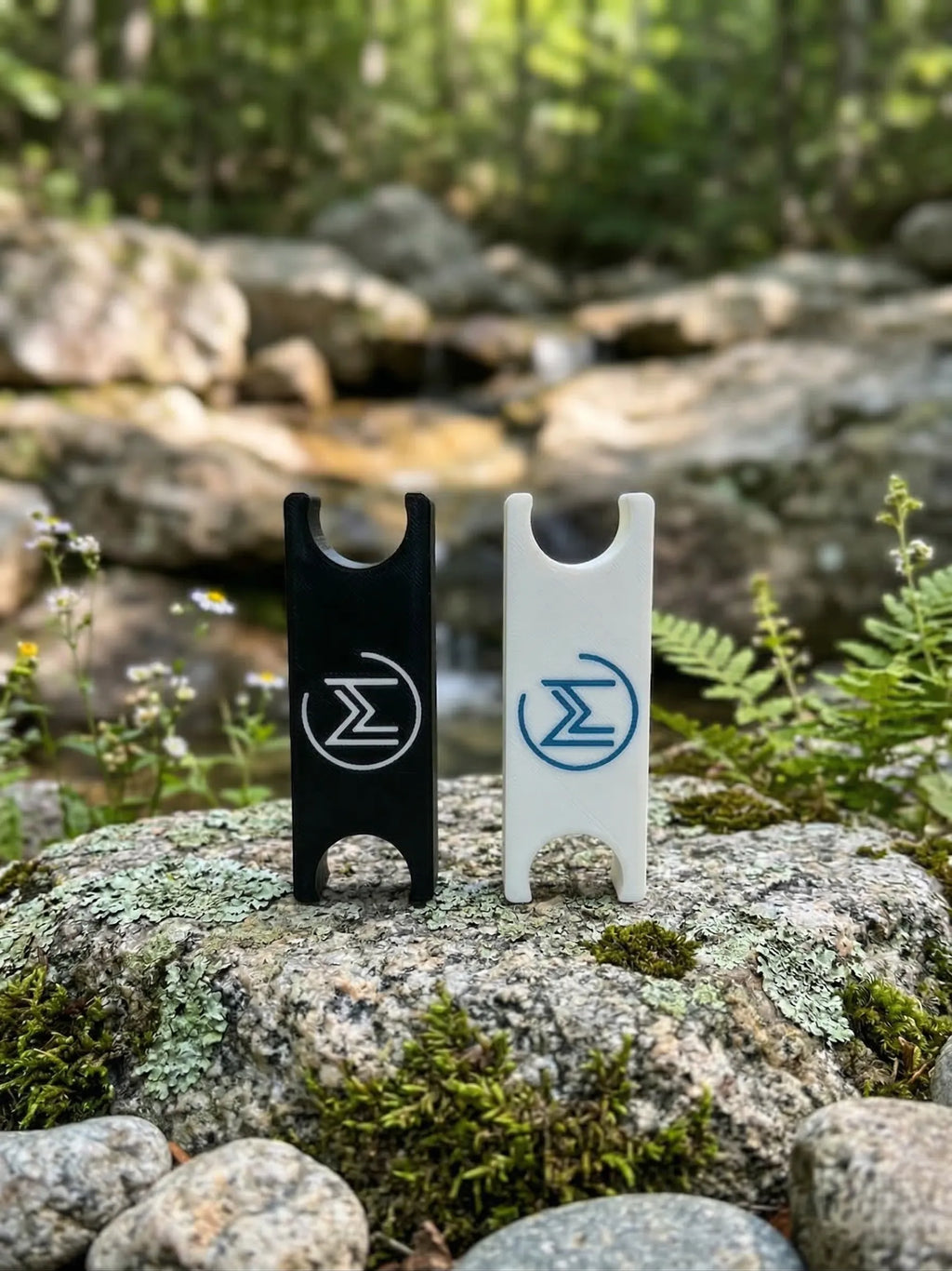 Black in-Motion Handy Clips resting on a rock outdoors