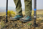 Close-up of boots and in-Motion Pro crutches on rocky terrain