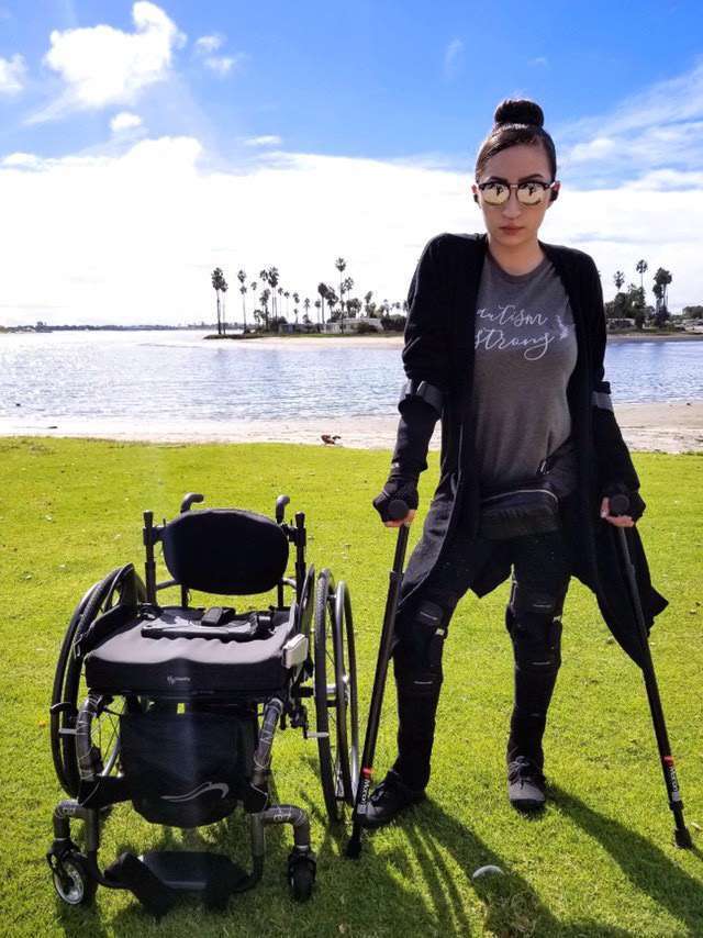 Person with in-Motion Pro forearm crutches beside a wheelchair by a lake