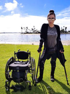 Person with in-Motion Pro forearm crutches beside a wheelchair by a lake